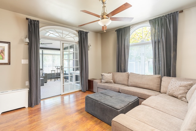 living room featuring ceiling fan and light hardwood / wood-style floors