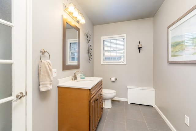 bathroom featuring vanity, toilet, and tile patterned floors