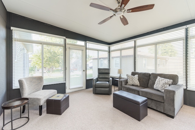 living room with ceiling fan, plenty of natural light, and carpet