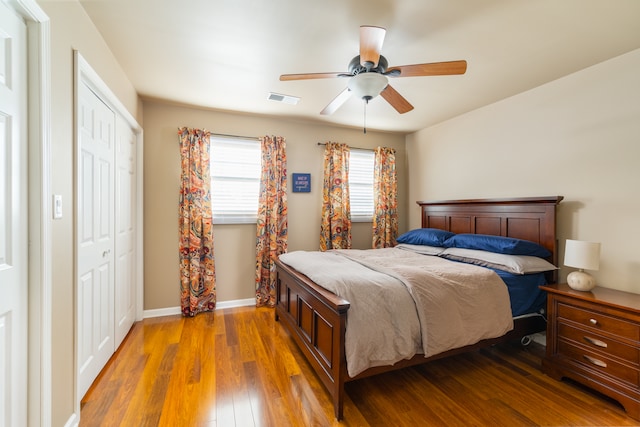 bedroom with a closet, ceiling fan, and hardwood / wood-style floors