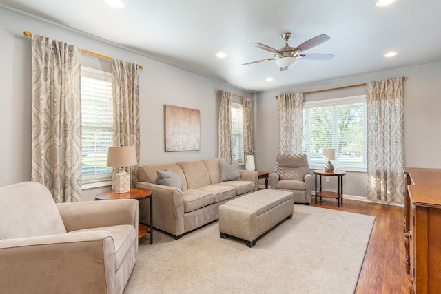 living room featuring hardwood / wood-style flooring, a wealth of natural light, and ceiling fan