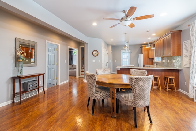 dining space featuring light wood-type flooring and ceiling fan