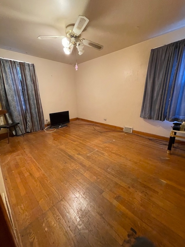 spare room featuring hardwood / wood-style floors and ceiling fan