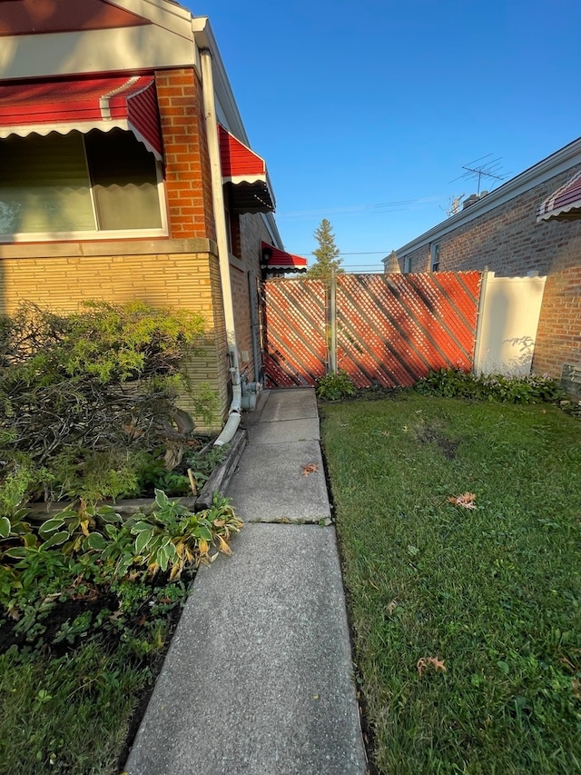 view of side of home featuring a yard