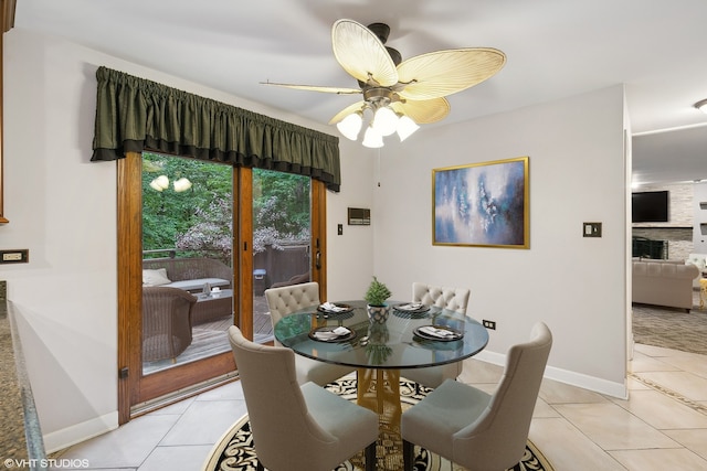 tiled dining space featuring ceiling fan