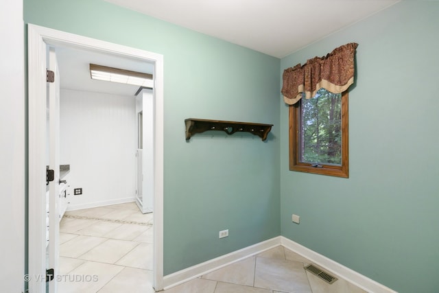 hall featuring light tile patterned flooring