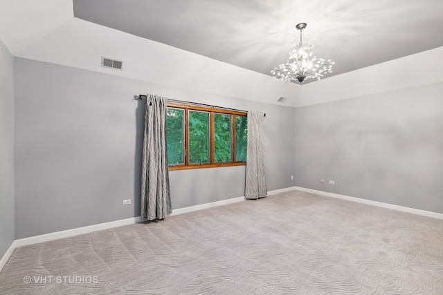 unfurnished room featuring lofted ceiling, an inviting chandelier, and light colored carpet