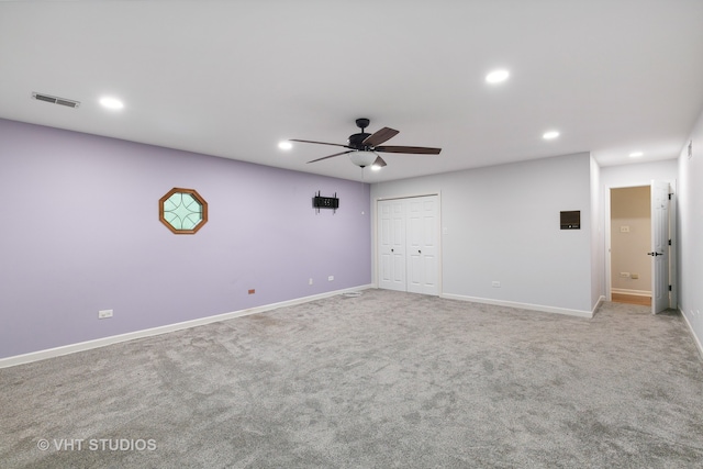 unfurnished bedroom featuring a closet, ceiling fan, and light colored carpet