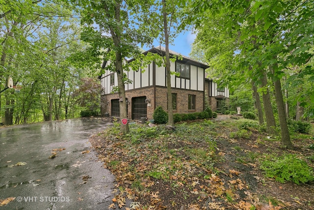 tudor house featuring a garage