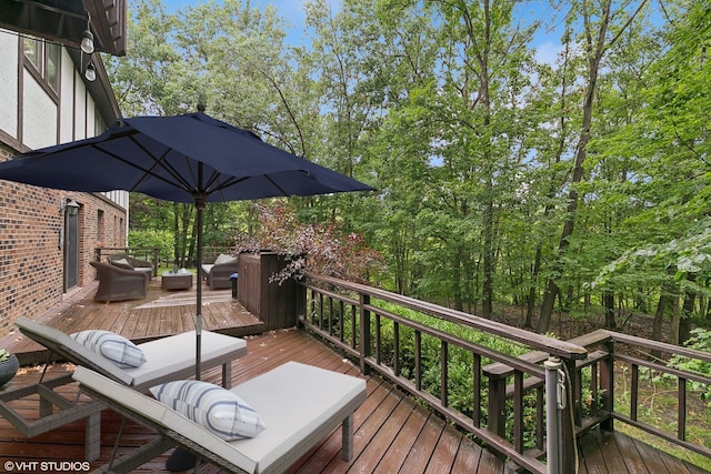 wooden terrace with an outdoor living space