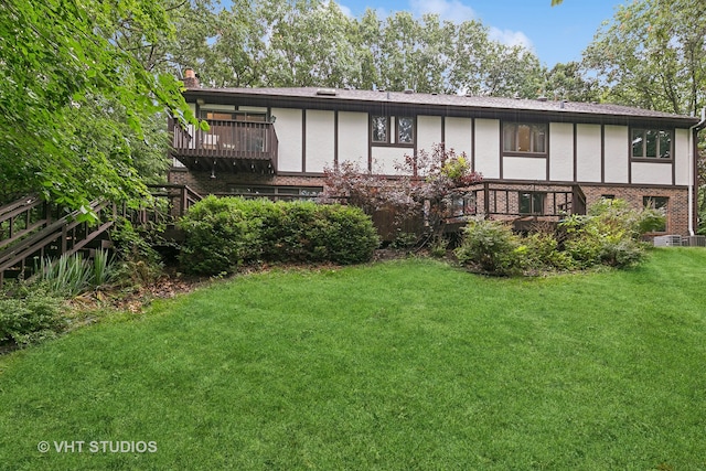 view of front facade with a front yard and a wooden deck