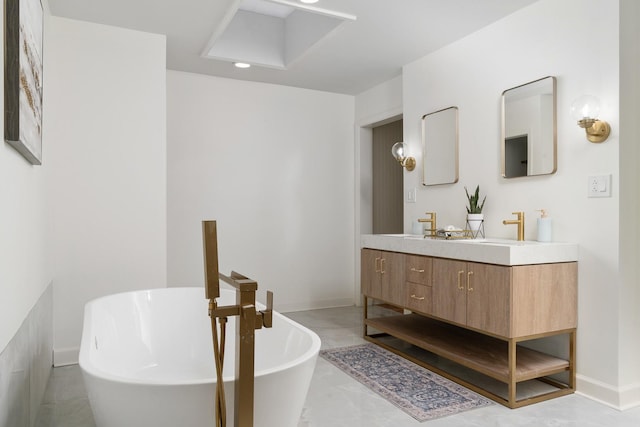 bathroom featuring a washtub and vanity