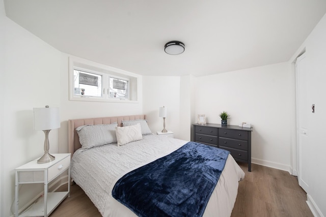 bedroom with hardwood / wood-style flooring