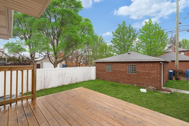 wooden terrace featuring a yard