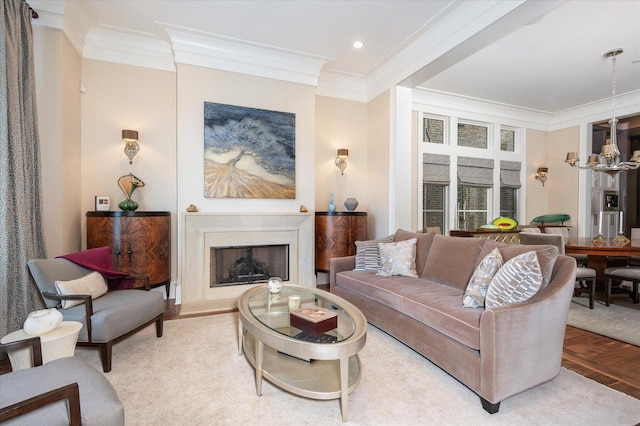 living room with a chandelier, recessed lighting, a fireplace with raised hearth, and crown molding