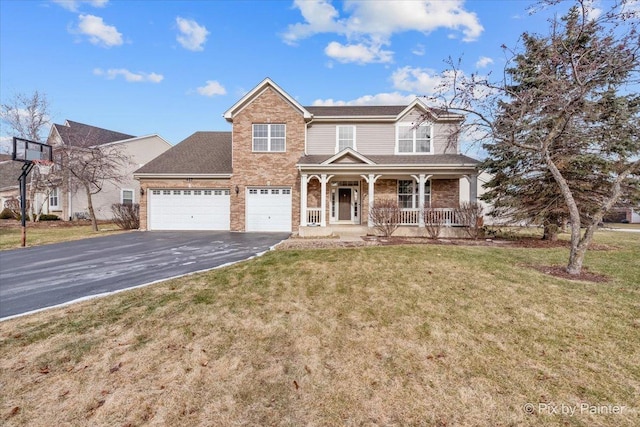 view of front of property featuring a garage, covered porch, and a front lawn