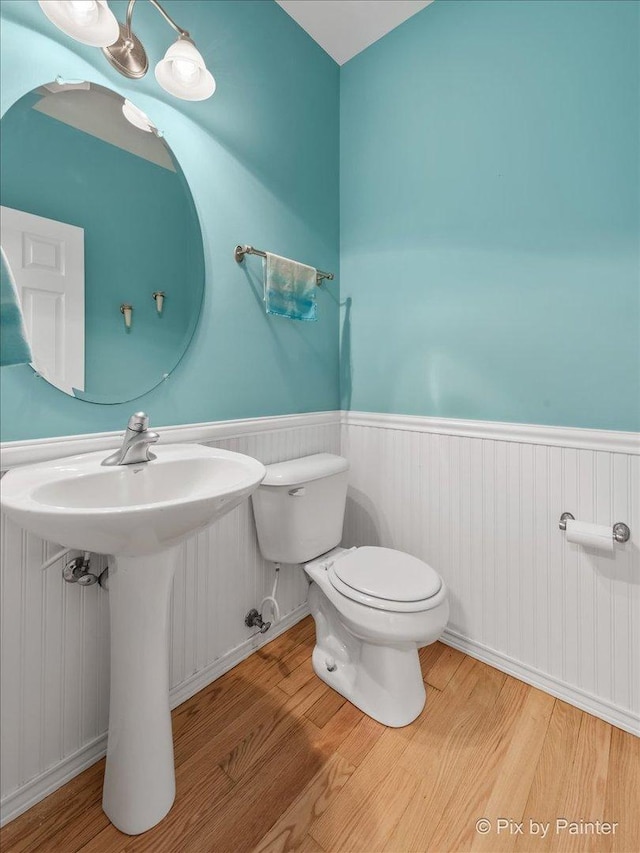 bathroom featuring hardwood / wood-style floors and toilet