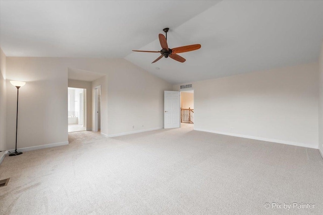 empty room with light carpet, vaulted ceiling, and ceiling fan