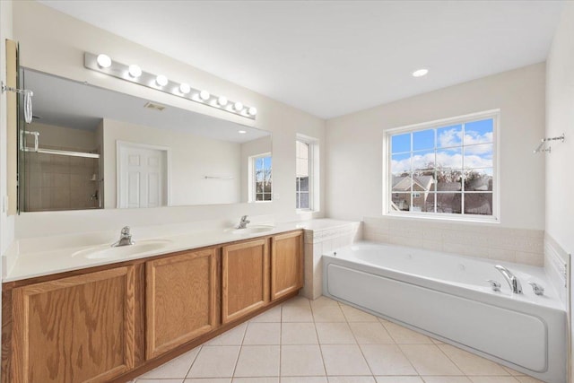 bathroom with tile patterned flooring, vanity, and separate shower and tub