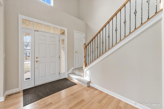 foyer entrance featuring hardwood / wood-style floors and a wealth of natural light