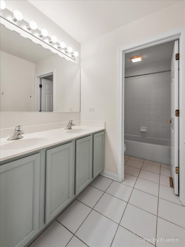 full bathroom featuring toilet, tile patterned flooring, vanity, and tiled shower / bath