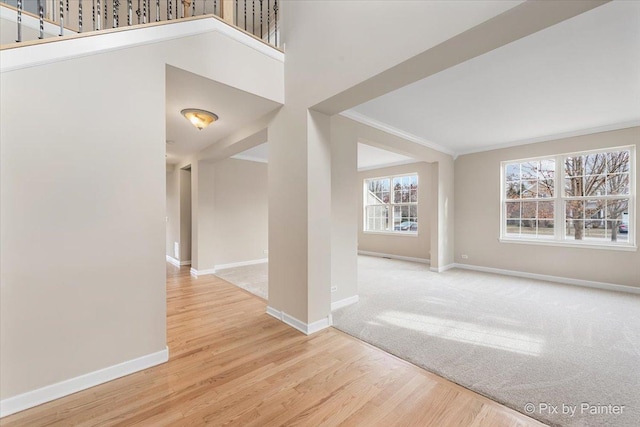 unfurnished room with ornamental molding and hardwood / wood-style flooring