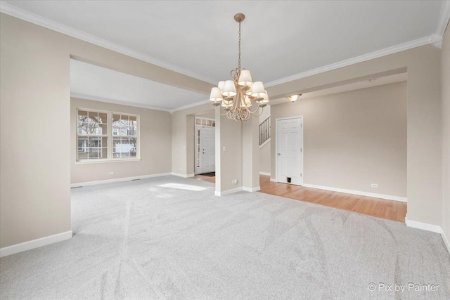 unfurnished room featuring a chandelier, carpet floors, and ornamental molding