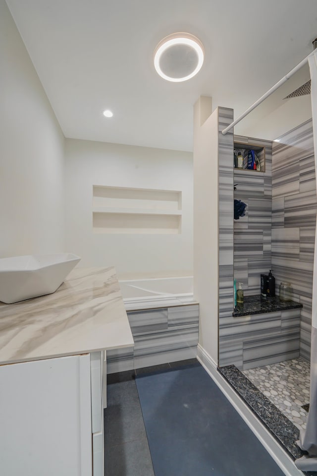 bathroom with vanity and independent shower and bath