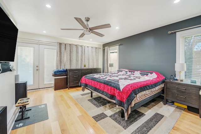 bedroom with light wood-type flooring, ceiling fan, and french doors