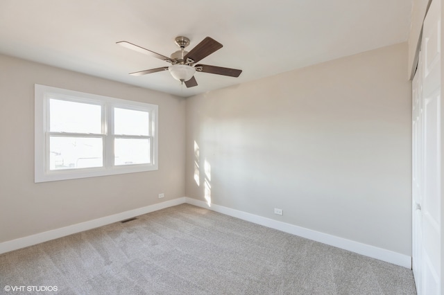 empty room with light colored carpet and ceiling fan