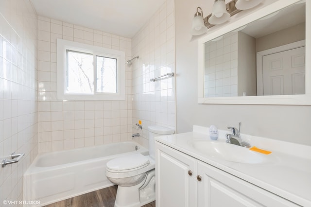 full bathroom featuring vanity, toilet, tiled shower / bath combo, and wood-type flooring