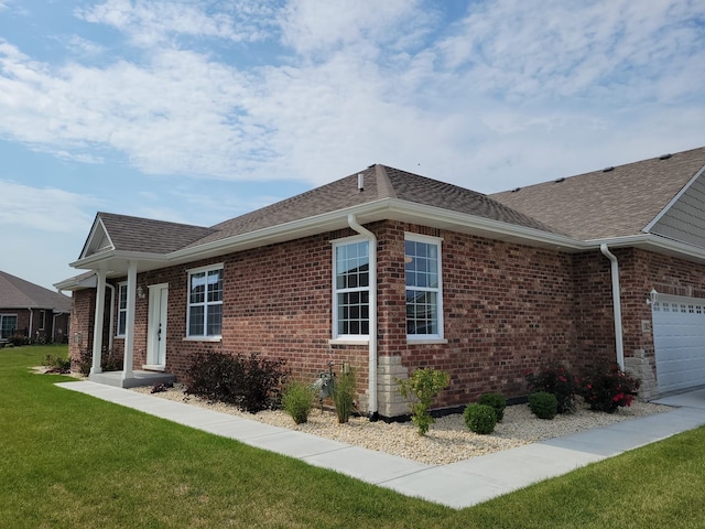 view of property exterior with a garage and a yard