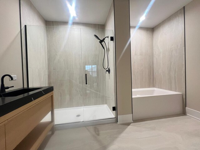 bathroom featuring vanity and separate shower and tub