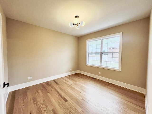 spare room with hardwood / wood-style flooring