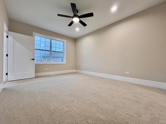 empty room featuring light colored carpet and ceiling fan