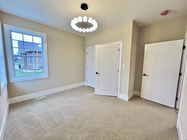 unfurnished bedroom featuring light carpet