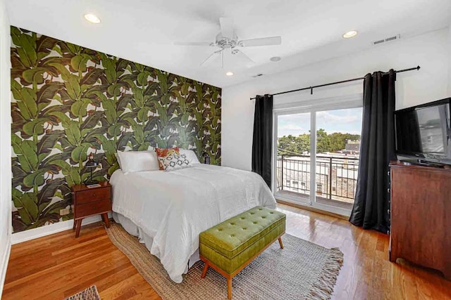 bedroom with ceiling fan, access to outside, and wood-type flooring