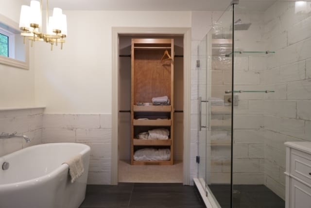 bathroom featuring tile patterned floors, a chandelier, tile walls, independent shower and bath, and vanity