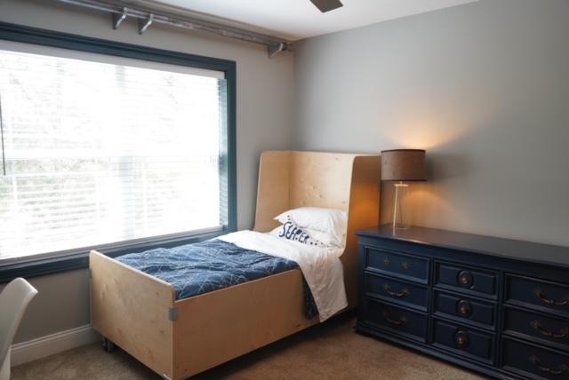 bedroom featuring multiple windows and carpet