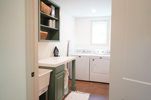 laundry room with cabinets, independent washer and dryer, and sink