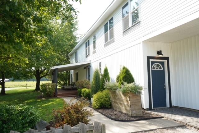 doorway to property featuring a yard and covered porch