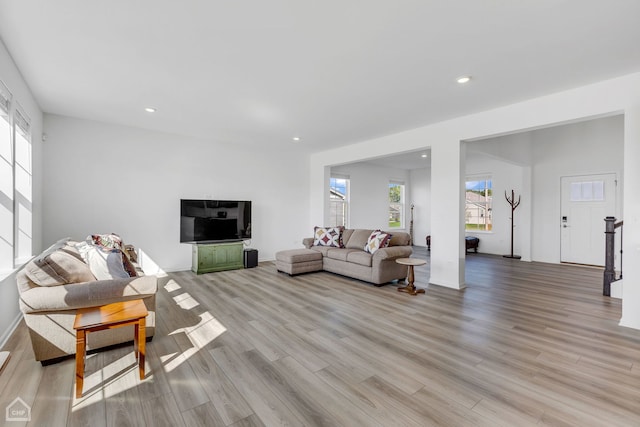 living room featuring a wealth of natural light and light hardwood / wood-style floors