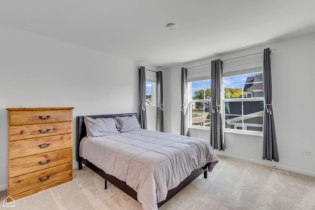 bedroom featuring light colored carpet