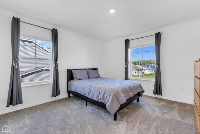 carpeted bedroom featuring multiple windows