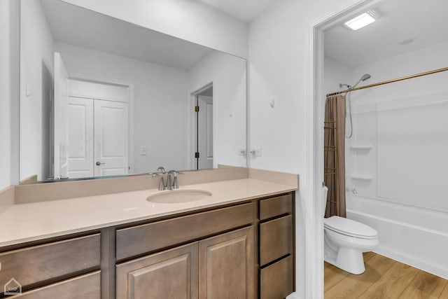 full bathroom featuring vanity, toilet, hardwood / wood-style flooring, and shower / bathtub combination with curtain