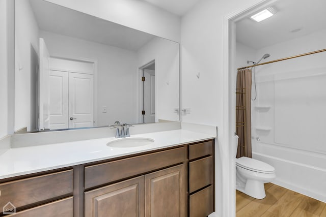 full bathroom featuring shower / tub combo, vanity, hardwood / wood-style flooring, and toilet