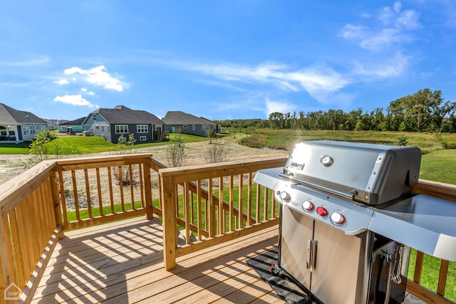 deck featuring grilling area and a lawn