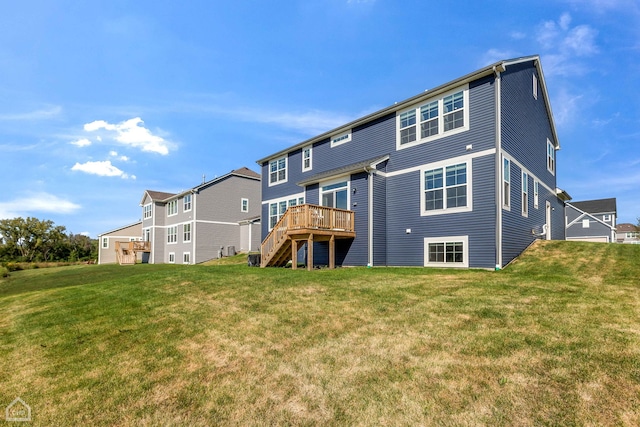 back of house featuring a wooden deck and a yard