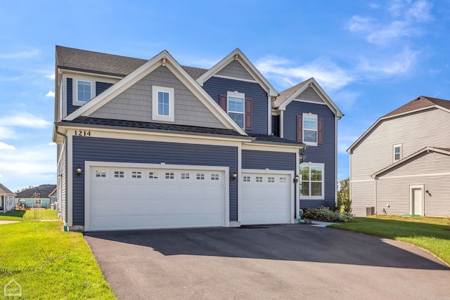 view of front of house with a garage and a front lawn