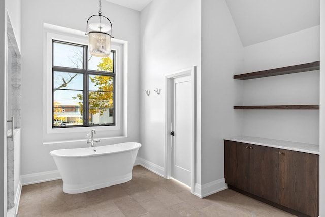 bathroom with lofted ceiling, a bath, and tile patterned flooring